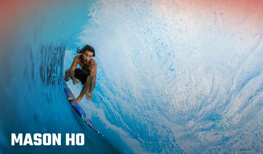 Mason Ho surfing inside a powerful blue wave, shown riding through the barrel with his name displayed.