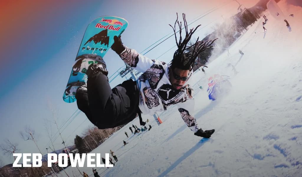Zeb Powell performing a snowboarding trick on a snowy slope, with his snowboard and name displayed on the image.