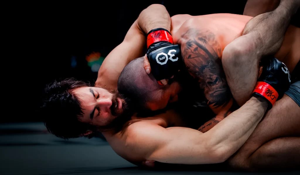 Kron Gracie in top position controlling Charles Jourdain on the ground during their UFC fight.