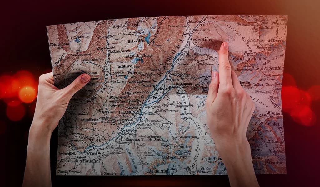 Hands holding a map showing Chamonix and surrounding mountain areas