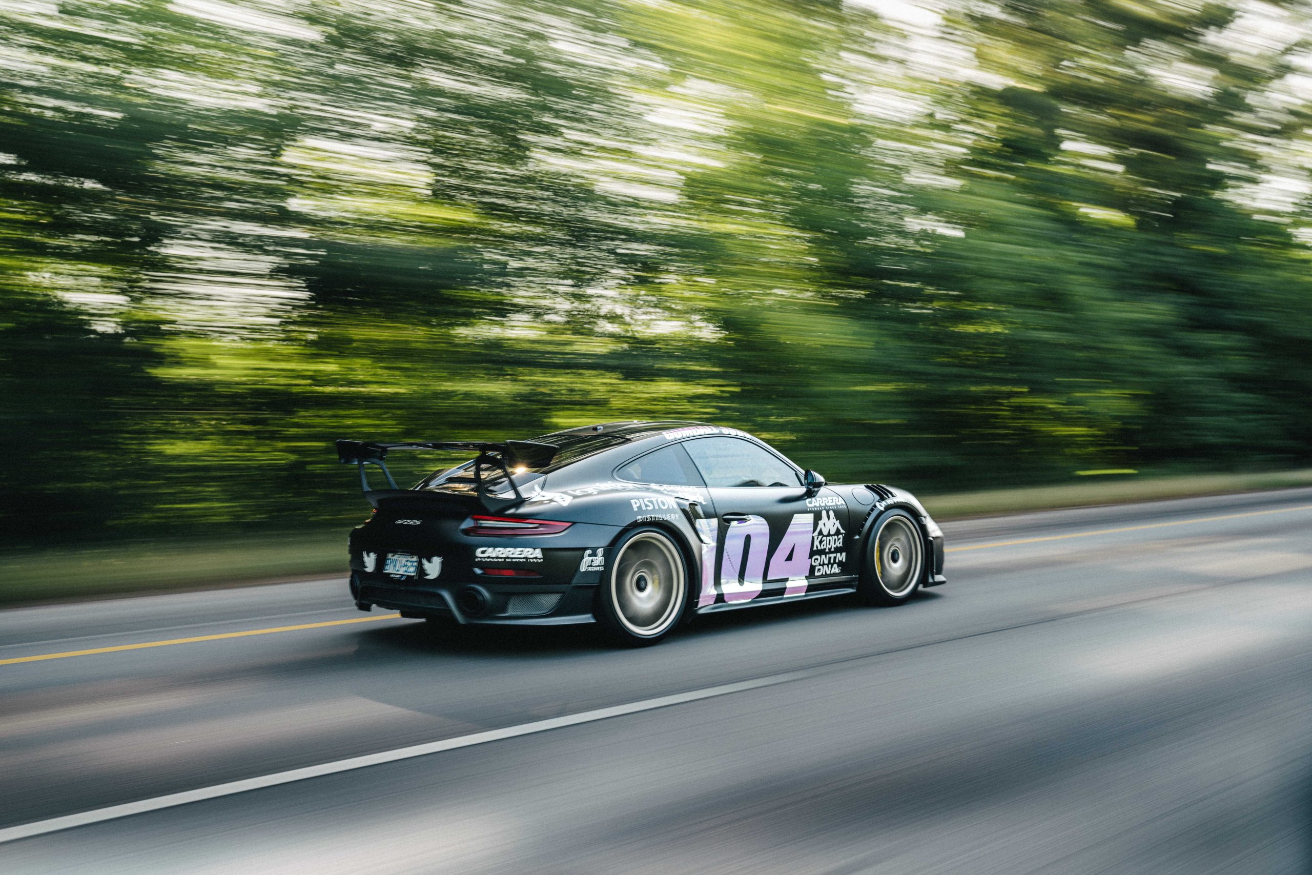 A Gumball rally car speeding on the road