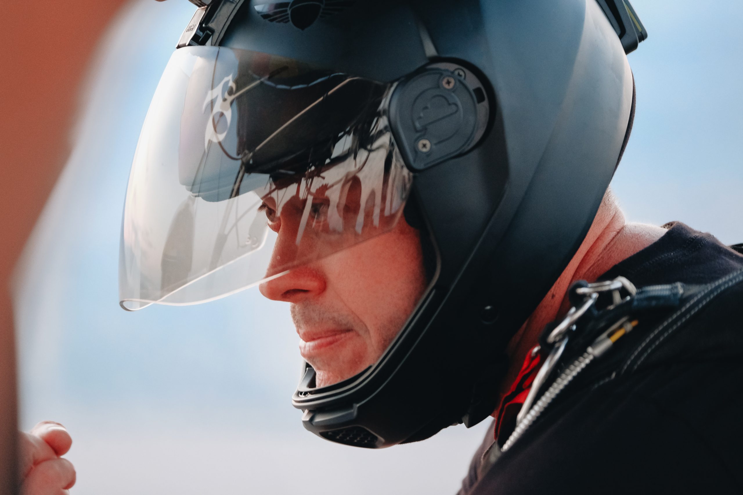 Skydiver and base jumper Jeb Corliss wears a helmet preparing to jump from an airplane